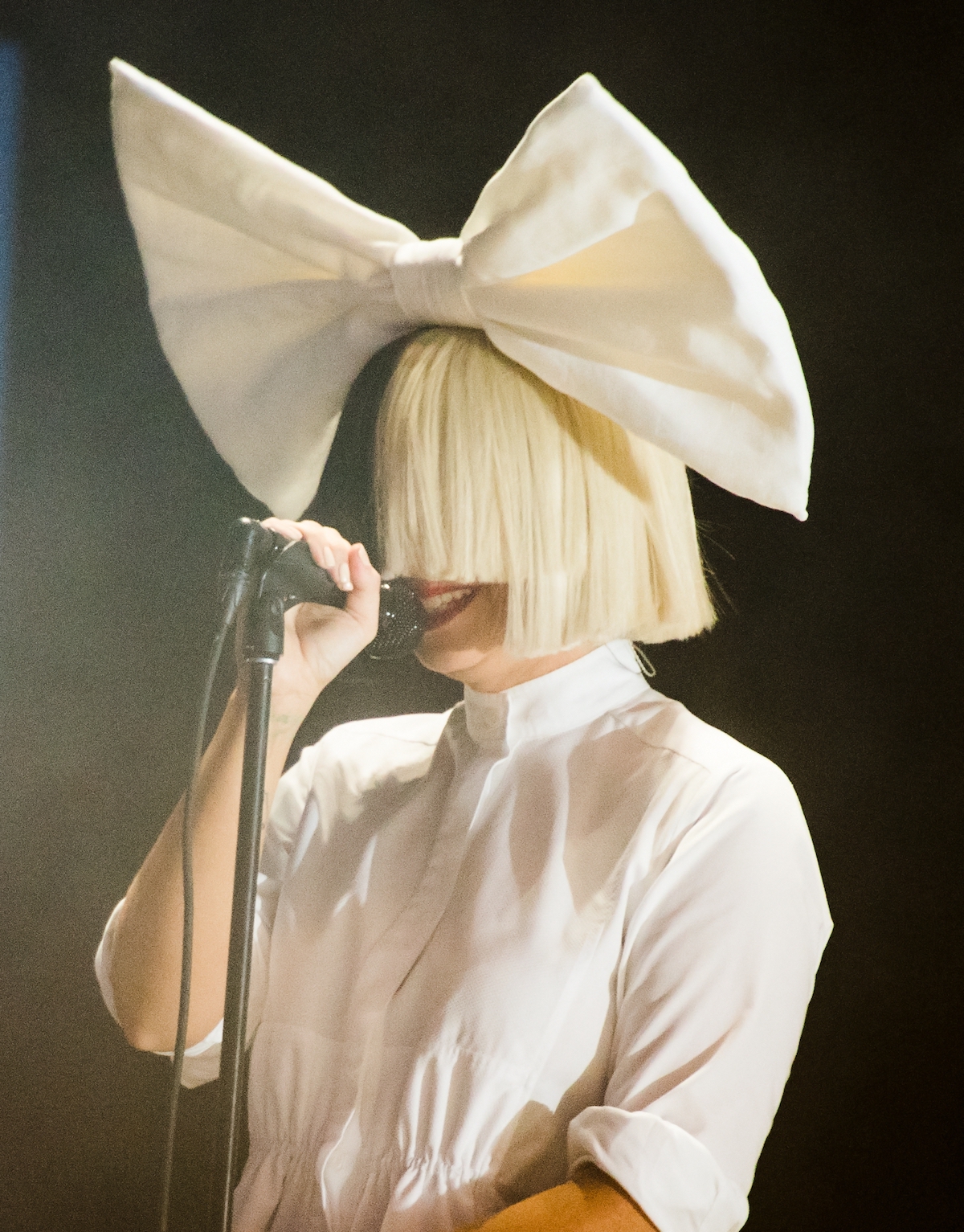 Sia singing at her concert.